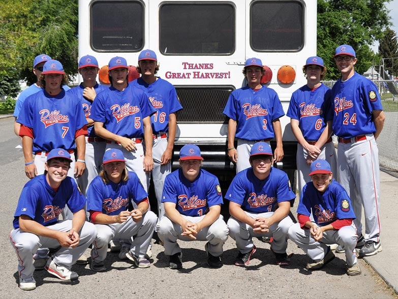 photo of the Dillon Cubs American Legion Baseball team in front of their team bus which reads “thanks, Great Harvest”