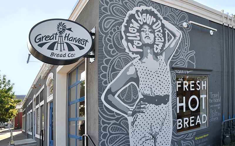 outside of a great harvest bakery with a mural on the side