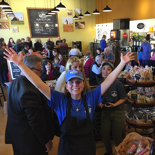 bakery owner smiling in front of her store