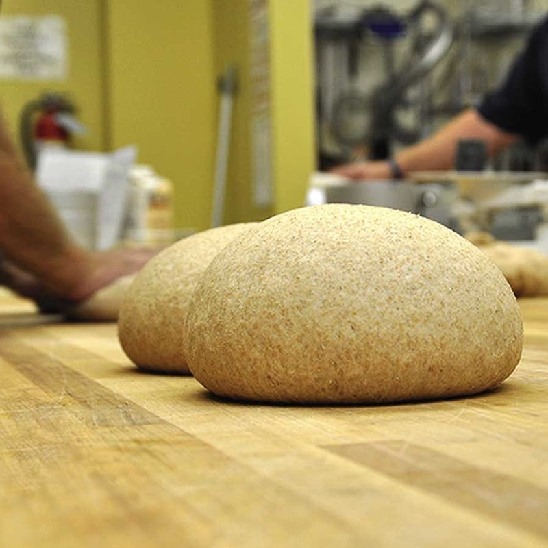 Loaf of great harvest dough on a wood table