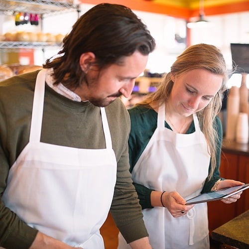 This is a photo of a bakery cafe trainer teaching a new franchisee